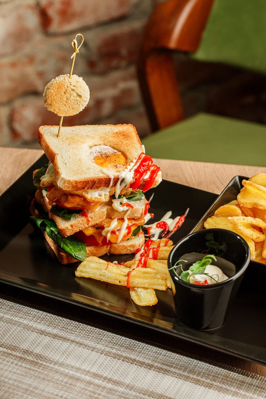 Club sandwich with chicken, egg and potatoes
