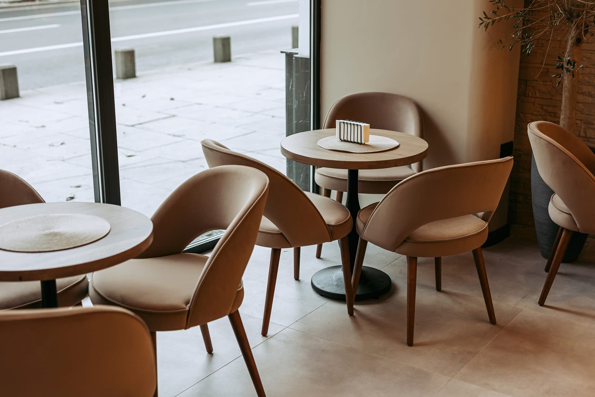 Warm stone, green upholstery and light from the boulevard.